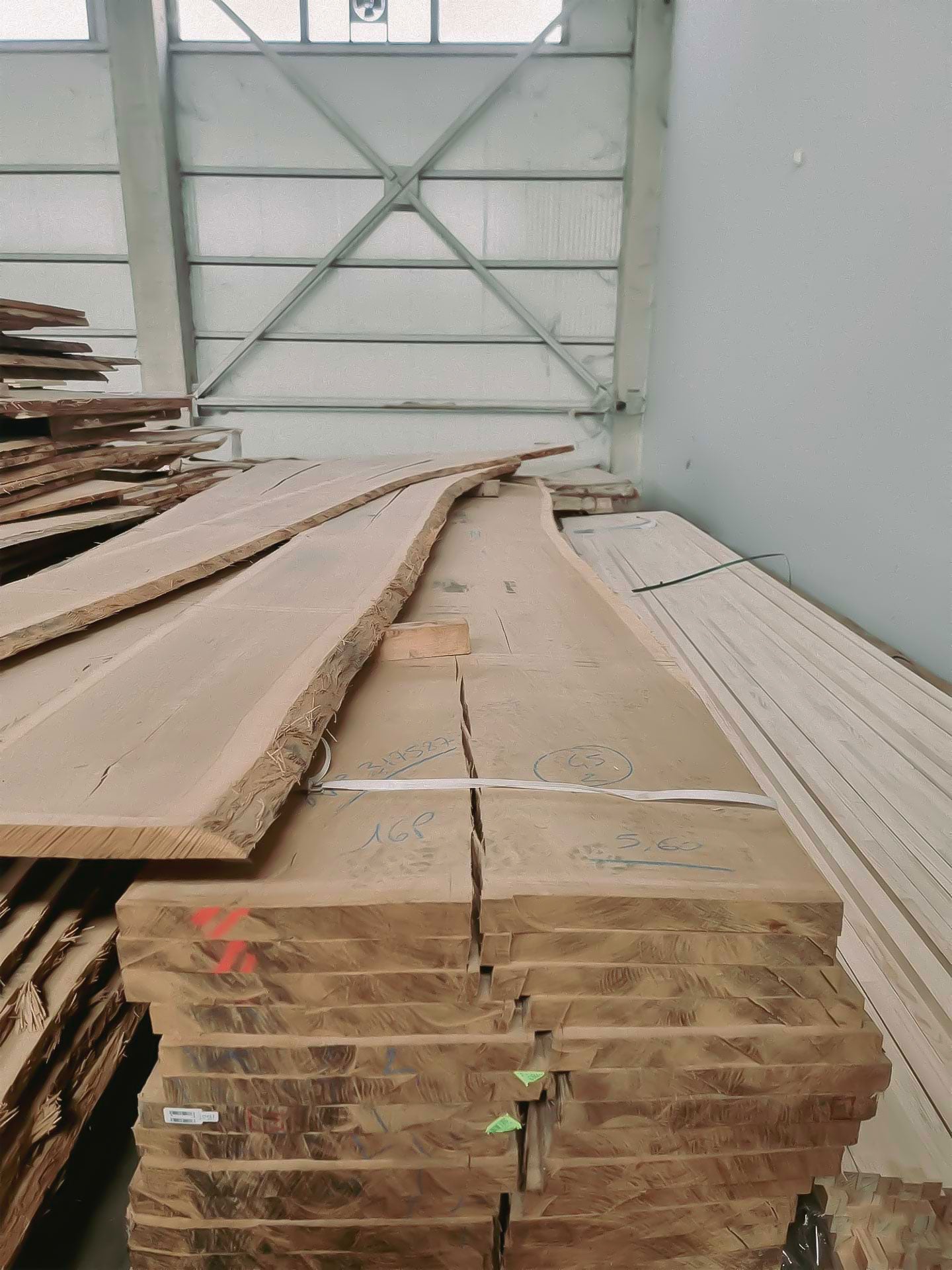 Workshop interior in Bulgaria's Troyan region with raw oak material, featuring wooden planks ready for crafting furniture.